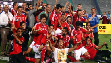 al ahly players celebrate with their trophy after winning their egyptian E7DF45