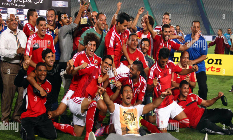 al ahly players celebrate with their trophy after winning their egyptian E7DF45